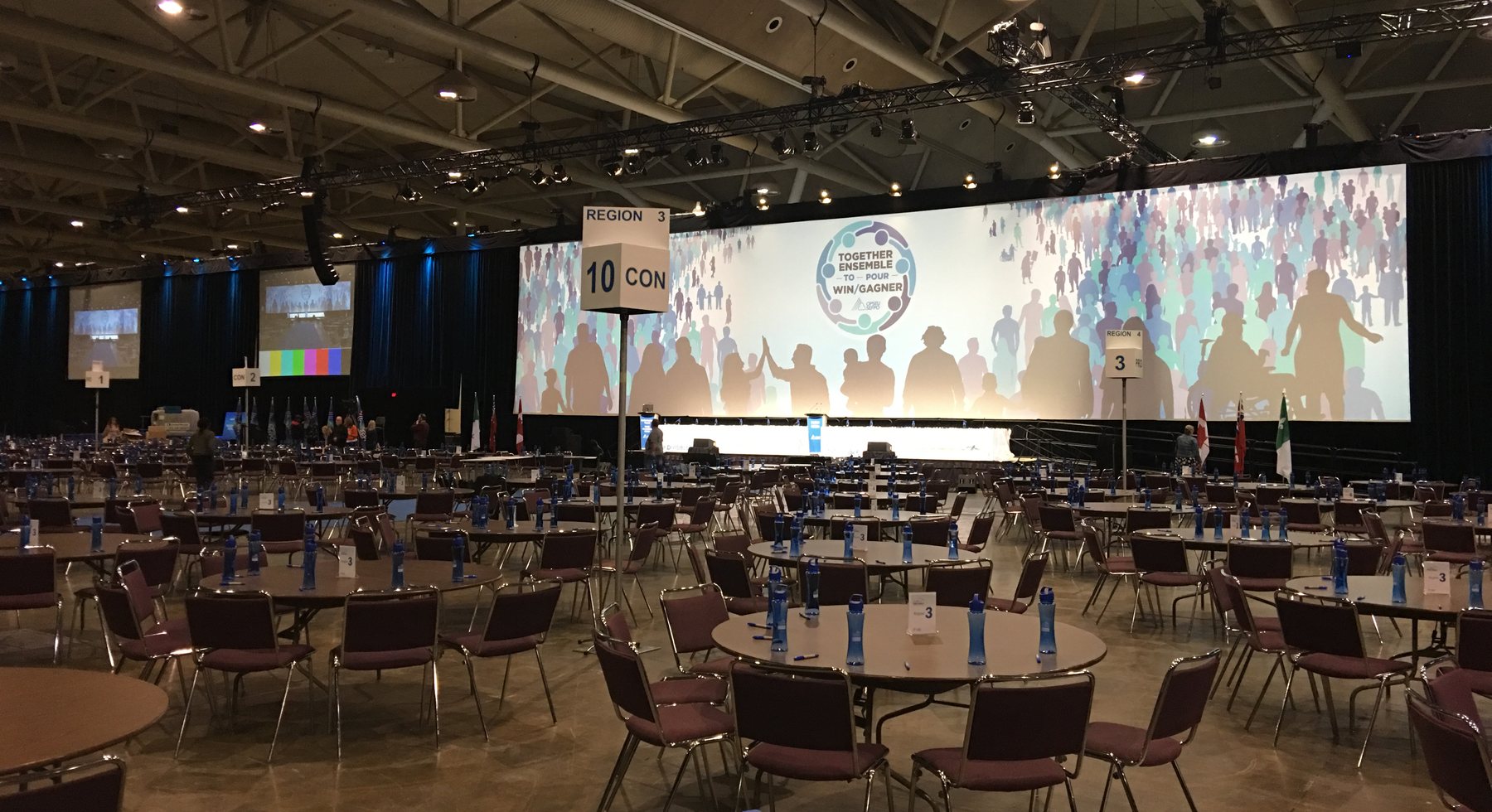 Large corporate general session room with wide projection and show setup